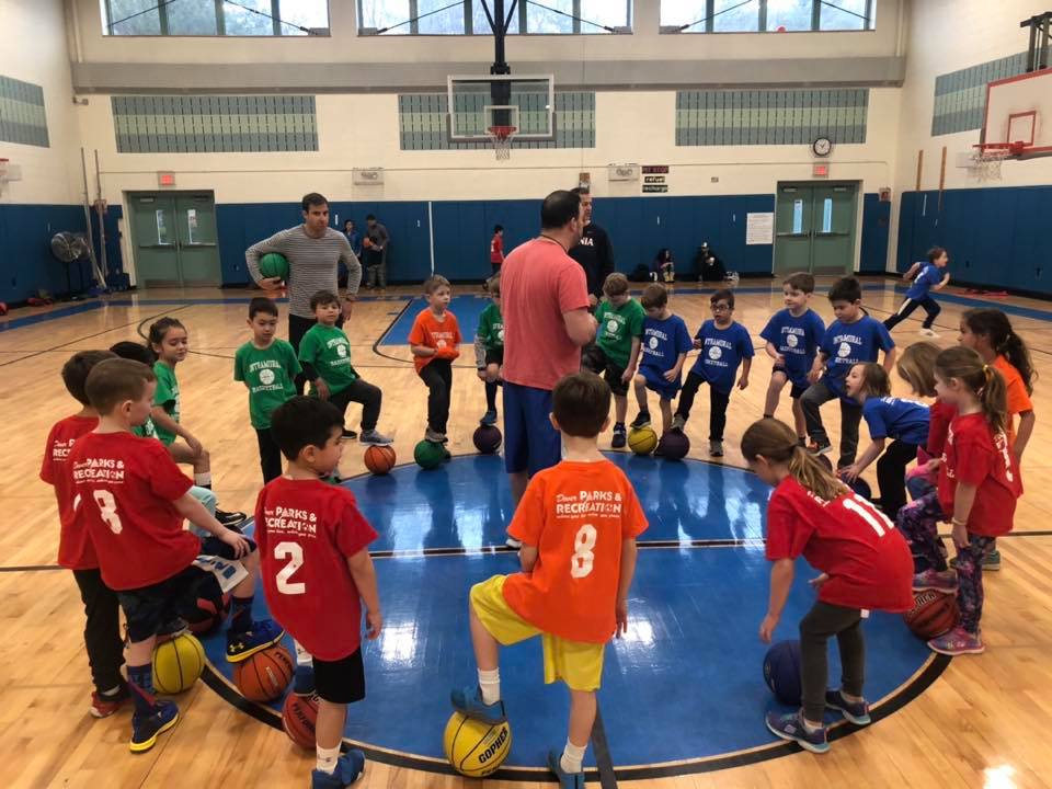 Photo of kids in huddle in gym